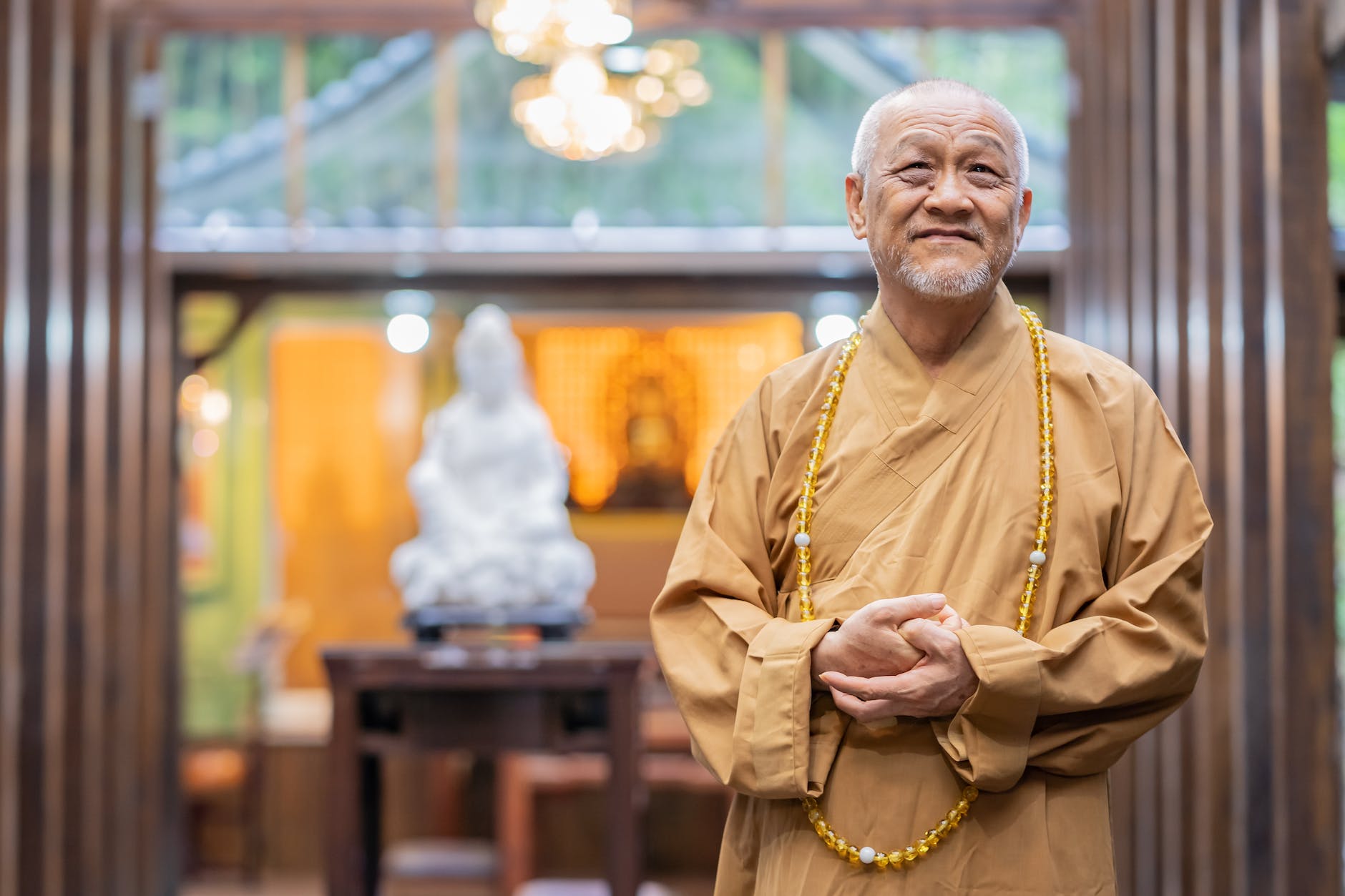 elderly monk smiling in a temple